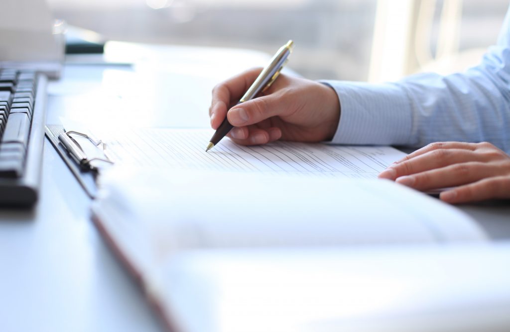 Businesswoman hands pointing at business document